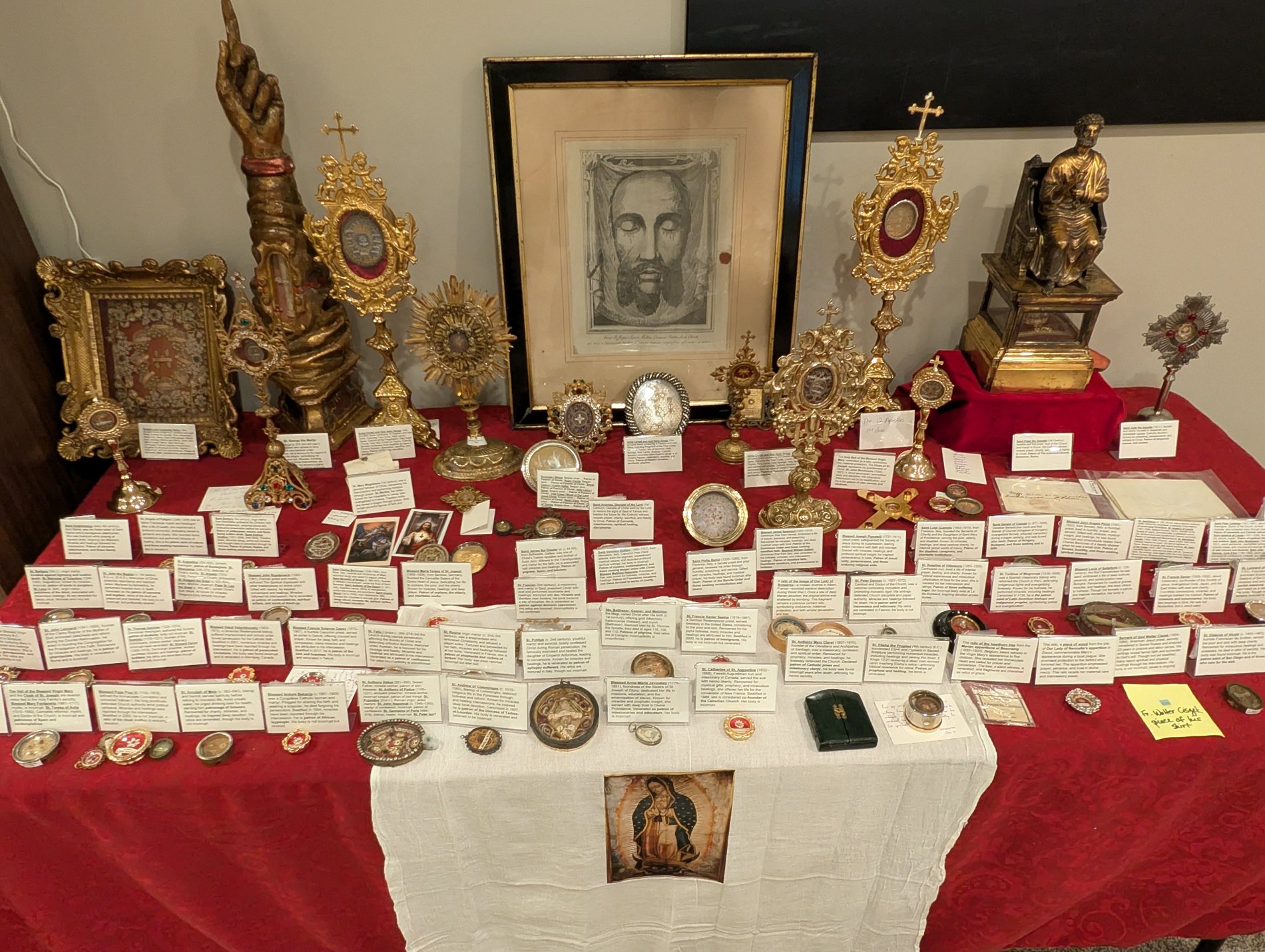 Chasing Saints relic table with reliquaries, sacred images, and relic cards